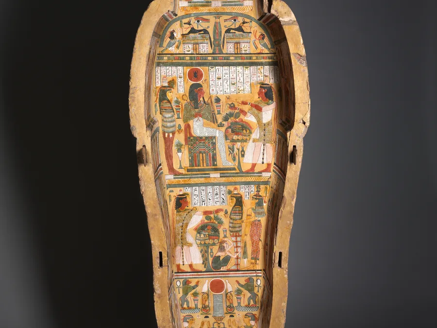 Painted Egyptian coffin base of Nesykhonsu with jackal imagery and funerary decoration.