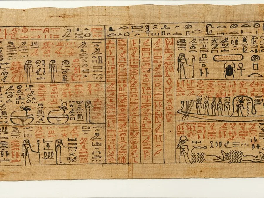 Long Egyptian Amduat papyrus with underworld scenes and columns of text.