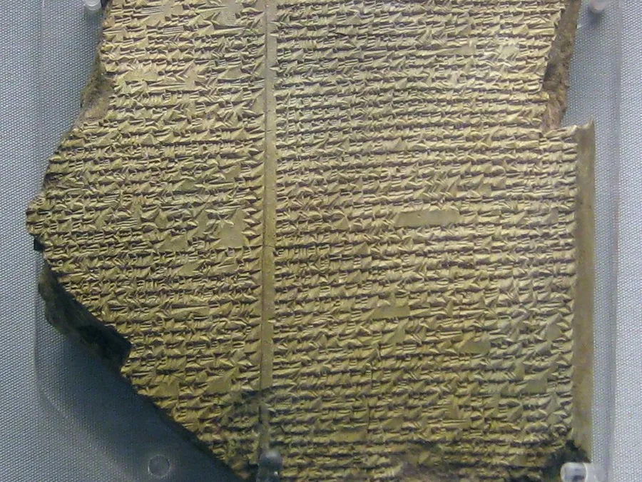 Neo-Assyrian clay tablet densely inscribed with cuneiform, broken at the edges.