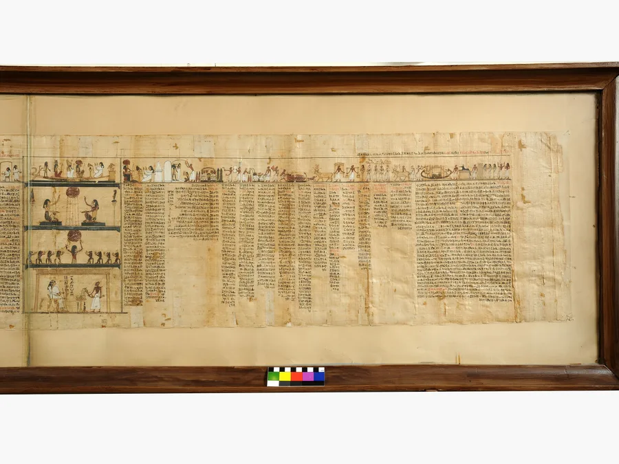 Color photograph of a Book of the Dead papyrus panel of Taysnakht with funerary scenes and Egyptian text.