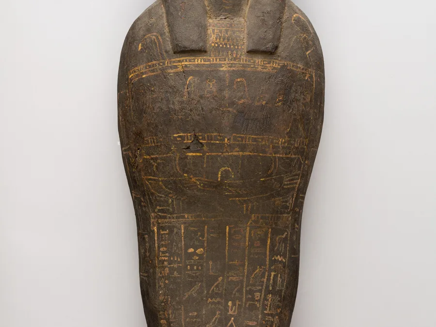 Egyptian coffin and corn mummy with painted Osiris mask and funerary imagery.