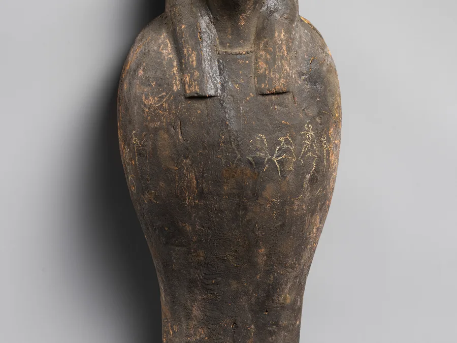 Egyptian falcon-headed coffin and grain mummy with Osiris mask.