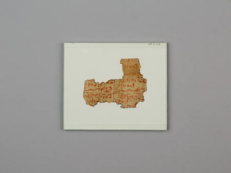 Egyptian magical papyrus fragment with ink text.