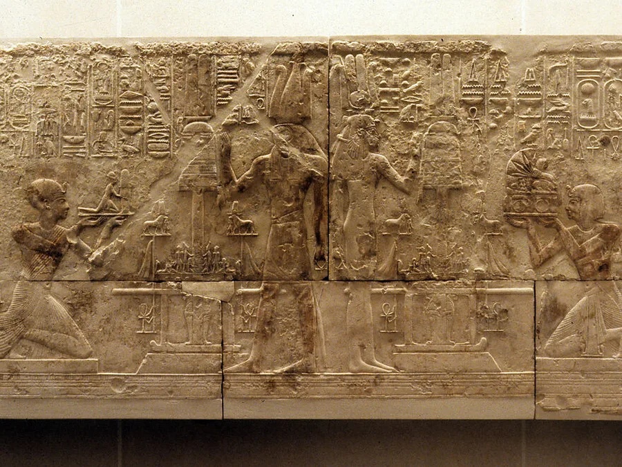 West wall limestone relief from the chapel of Ramesses I with offering scenes, Osiris symbols, and hieroglyphic inscriptions.