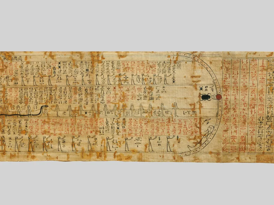 Long Egyptian Amduat papyrus with registers of underworld figures and cursive hieroglyphs.